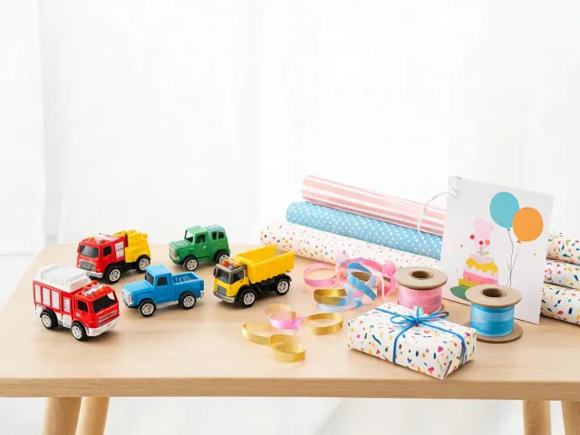 Gift table with toy truck collection and wrapping paper